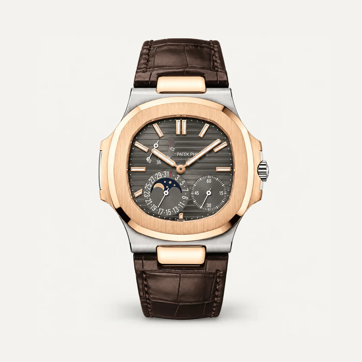 Patek Philippe Nautilus Moon Phase 5712GR، ميناء رمادي أردوازي · لون الذهب الأبيض والوردي · حزام جلدي — صورة توضيحية وليست صورة للقطعة
